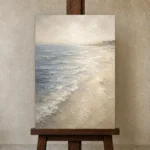 Misted Blue Coastal Living Room Wall Art Canvas Print displayed on a studio easel
