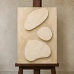 Serene Ivory Plaster Minimalist Wall Art Canvas Print displayed on a studio easel