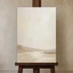 Warm Beige Horizon Minimalist Wall Art Canvas Print displayed on a studio easel