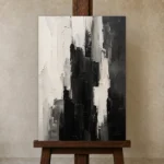 Black And White Abstract Monochrome Wall Art Canvas Print displayed on a studio easel