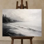 Fogbound Shoreline Monochrome Wall Art Canvas Print displayed on a studio easel
