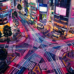 Magenta and cobalt tokyo city wall art featuring a glowing Tokyo crossing with illuminated streets, reflective pavement, and dramatic nighttime architecture for elegant interiors